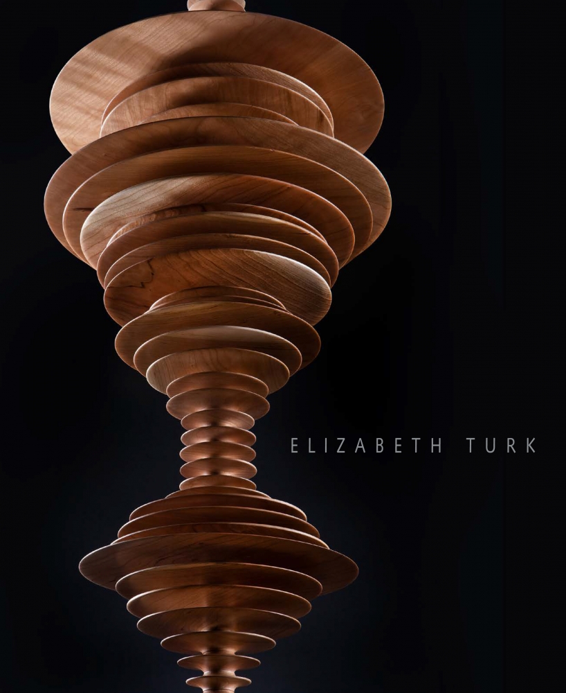 cover to exhibition catalogue for Elizabeth Turk, "Tipping Point—Echoes of Extinction", showing wooden discs stacked on each other