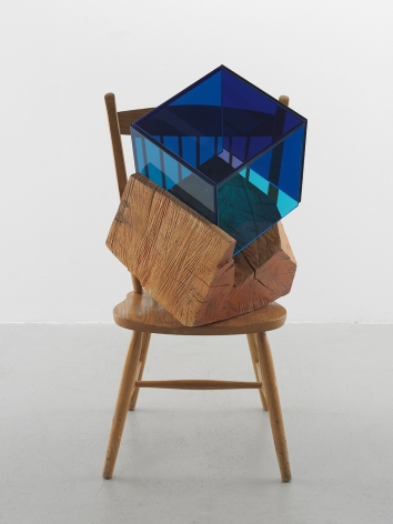 a sculpture by Sarah Braman of a dining chair fused with multi-colored glass panels