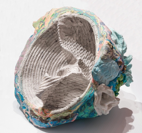 a sculpture by Lily Cox-Richard of basket forms pressed together inside a shell of multicolored swirls