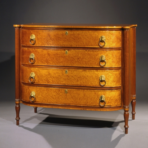 Bowfront Chest of Drawers in the Sheraton Taste, about 1815 Eastern Massachusetts, probably Boston, possibly Thomas Seymour. Cherry, mahogany, bird’s eye maple, striped maple, and ebony, with original gilt-brass lion-head pulls. 37 5/16 in. high, 43 5/8 in. wide, 23 7/16 in. deep