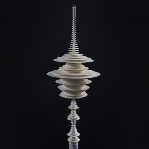 a sculpture by Elizabeth Turk of 3D-printed discs stacked and arranged to simultaneously resemble a Modernist abstraction and a sound wave