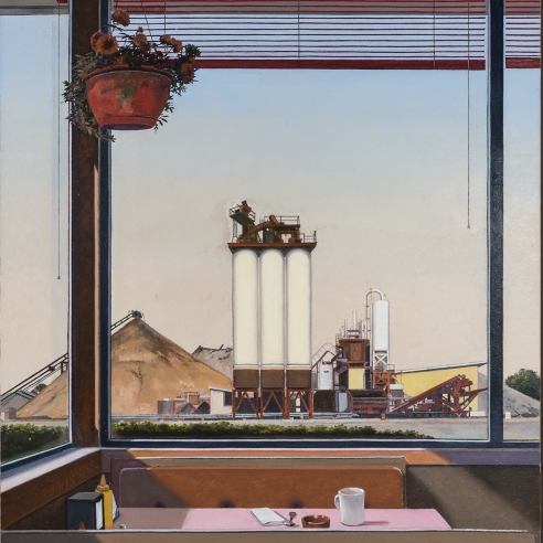 a table in a diner with an industrial landscape through the window