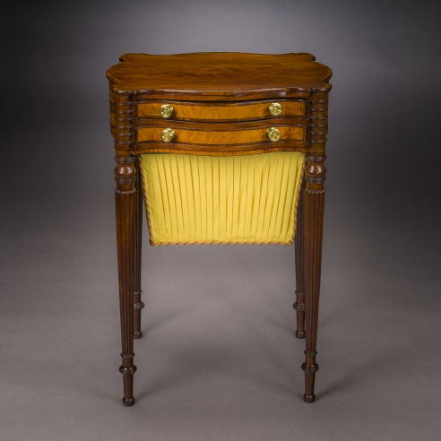 Work Table in the Sheraton Taste, about 1810. Attributed to Thomas Seymour, Boston. Mahogany, striped and bird’s eye maple, and ebony, with gilt-brass drawer knobs, and fabric work bag, 27 3/4 in. high, 19 1/4 in. wide, 15 3/4 in. deep
