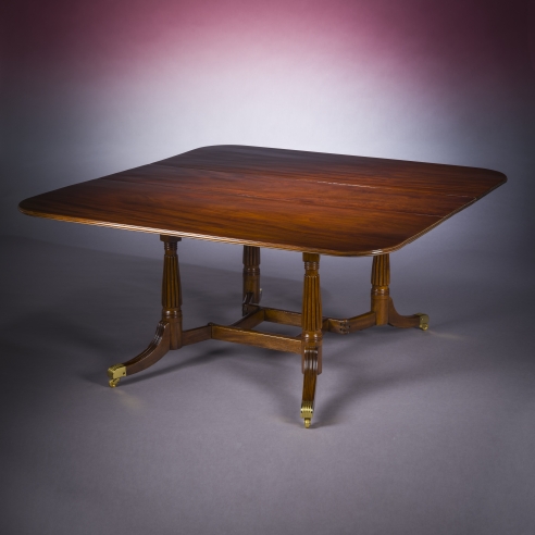 Cumberland-action Dining Table, about 1815–20. Attributed to Thomas Seymour, possibly for Isaac Vose, Boston. Mahogany, with gilt brass toe-caps and castors 28 3/4 in. high, 62 1/4 in. long, 60 in. wide; with leaves down, 17 in. wide, 62 1/4 in. long 
